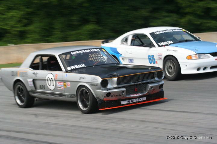 Jason racing a vintage Mustang on a road course